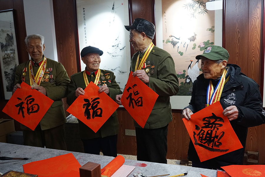 5 （抗老送福）春节到来之际，江南书画艺术研究院院长裴正荣特意请来4位抗战老兵,他们是98岁的徐元甫、94岁的袁有卿，92岁的夏夕生，89岁的仲金林共同学练写福字,老兵说我们长枪大炮等都拿得动.但对一支毛笔拿不来,手会抖,,,他们过上开心愉快的－天。以表达对革命老前辈无限敬仰和节日祝福还送上爱心大礼包。摄影：裴露.JPG